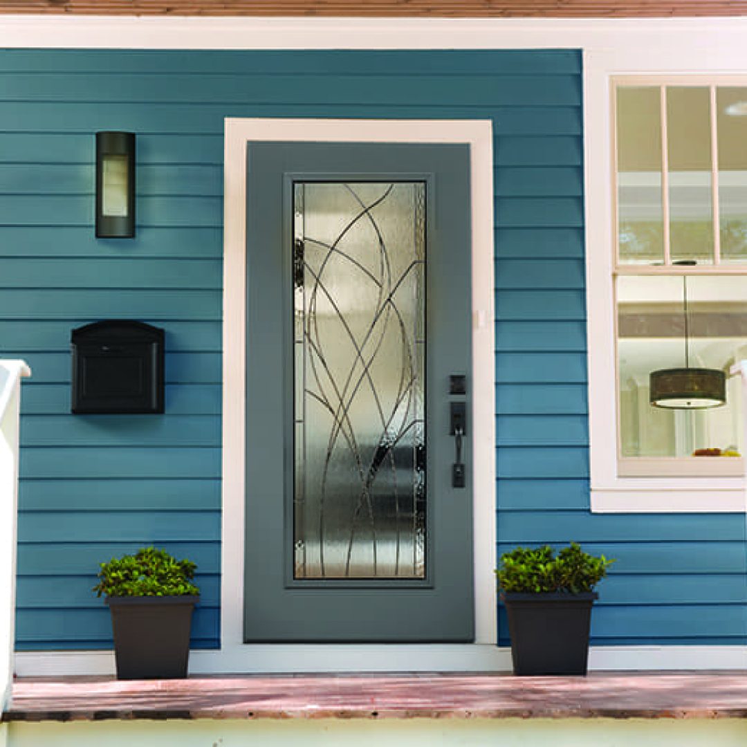 Technician installing a secure new front door at a South Haven, MI lakeside cottage