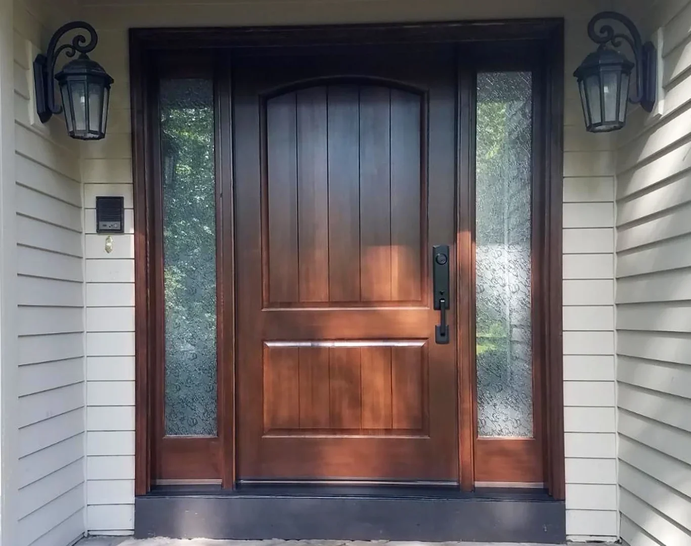 Experienced installer checking an entry frame and hardware fit before final door placement
