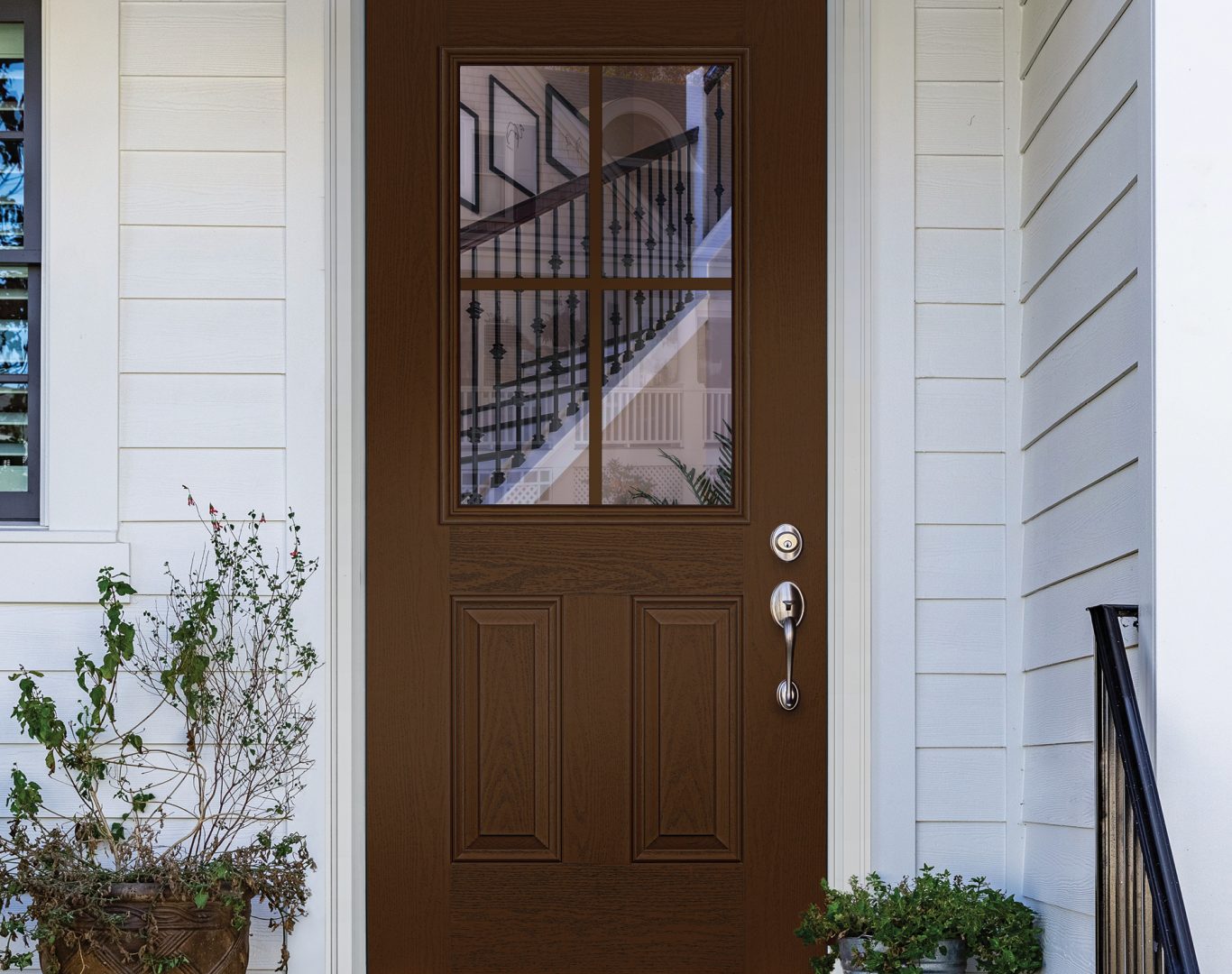 Technician aligning a replacement front door on a Paw Paw home with careful frame adjustments