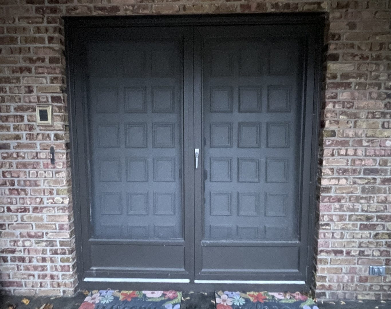 Installer fitting a new front door on a Gobles home with precise alignment and trim work