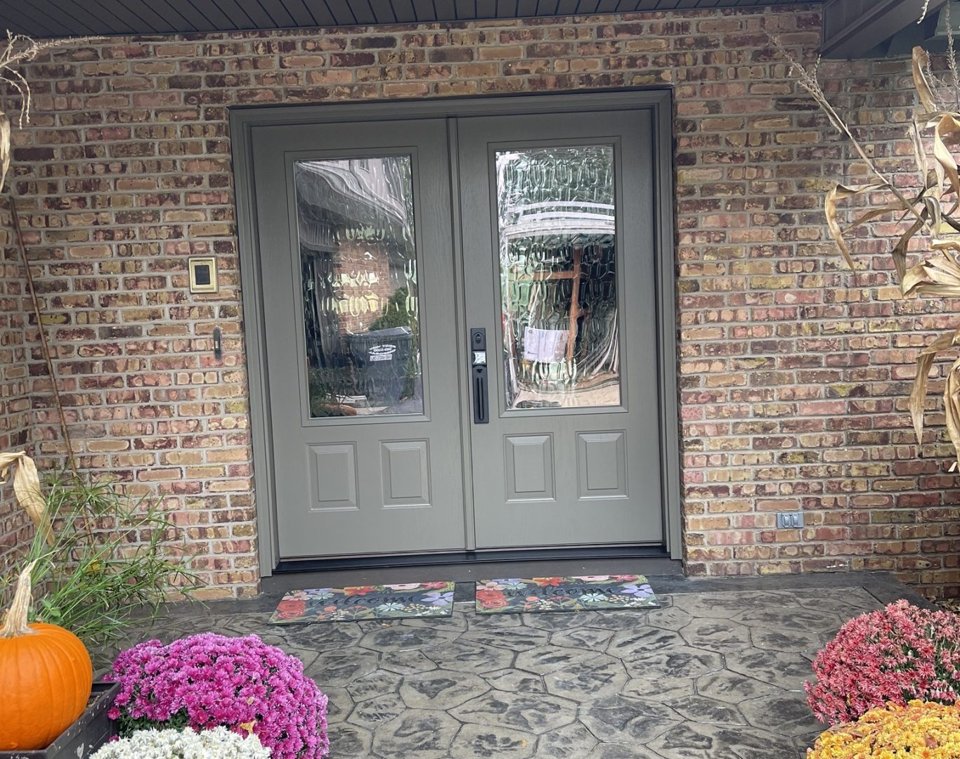 Skilled installer inspecting door frame details before finalizing a replacement entry door