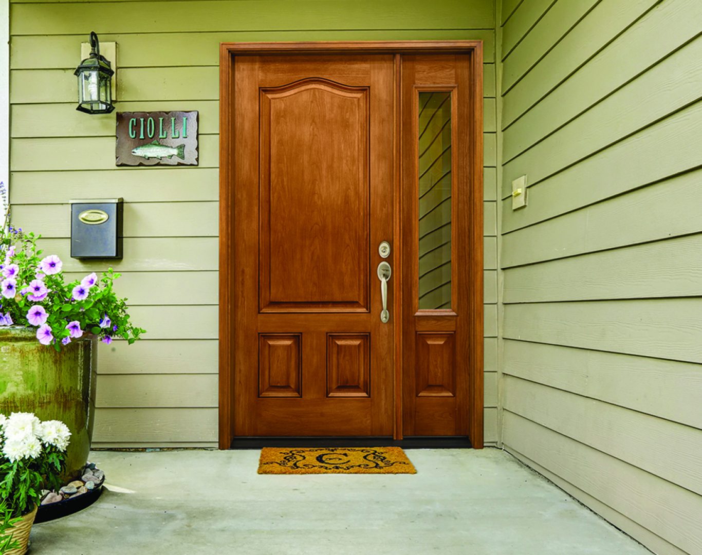 Installer measuring and securing a new entry door in a classic Kalamazoo, MI home on a sunny morning